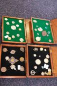 An album of various charms together with seven collectors trays of silver fobs, St Christopher's,