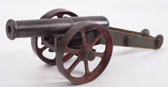 A Victorian iron and steel cannon: the 8 1/2 inch two stage barrel on a green painted steel frame