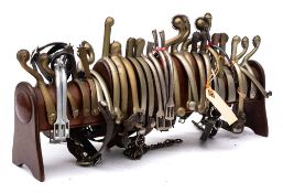 A collection of fifteen pairs of metal spurs: including a pair by Harvey & Co Ltd,