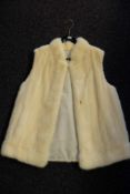 A Ladies white mink gillet: with silk lining, unsigned.