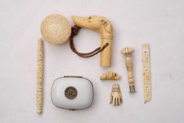A late 19th century carved ivory dog's head whistle: together with a carved ivory seal,
