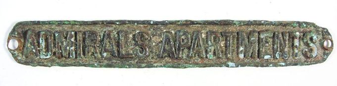 A group of salvaged artifacts comprising bronze plaque 'Admirals Apartments' 20cm long: a circular