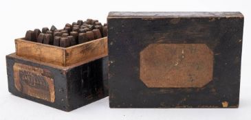 An early 20th century boxed part set of steel alphabet punches: 'Q' and '9' missing,
