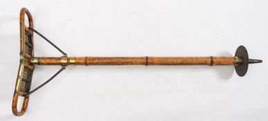 An early 20th century Continental bamboo, brass and wicker shooting stick: stamped 'Bte. SDGD'.