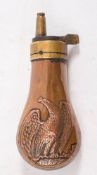 A brass and copper Colt style pistol powder flask with eagle decoration 11cm long:.