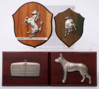 A Mercedes radiator badge on wooden plinth: together with a Ferrari badge and a Lamborghini badge