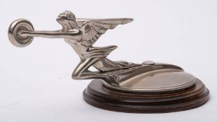A 1930s Packard Goddess car mascot: with outstretched arms holding a wheel,