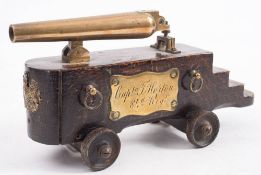 A 19th century brass desk cannon:, the six inch brass barrel with screw adjust cascabel,