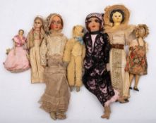 A small group of early 20th century dolls: comprising a wax head doll(damaged) two wooden peg dolls