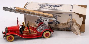 A tinplate clockwork fire engine:, with silver turntable and ladder, red lithograph printed cab,