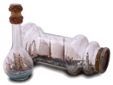 An early 20th century ship in a bottle: the three masted vessel set full sail with black and red