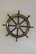 A teak and brass helm for the Vospers & Co Ltd launch 'Ruby':,