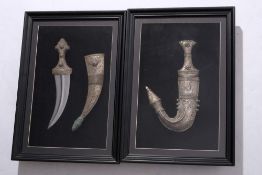 Two framed Persian white metal presentation jambiyas: of traditional from with curved blade and