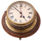A circular brass 8-day bulkhead clock by Smiths:,