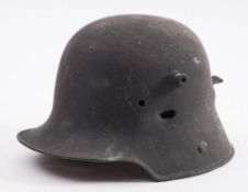 A WWI German M16 pattern helmet with bullet strike to one side and exit damage to rear: (over