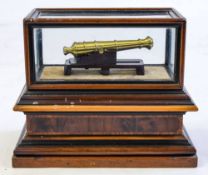 A cased mahogany and brass scale model cannon:,