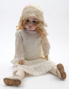 A late 19th /early 20th century German bisque head doll:, with applied blonde wig,