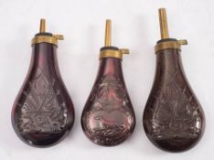 Three copper and brass reproduction powder flasks: with repousse decoration to bodies(3).