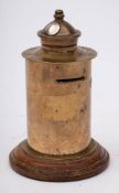 A WWI trench art money box modelled in the form of a Post box: mounted on a wooden socle,
