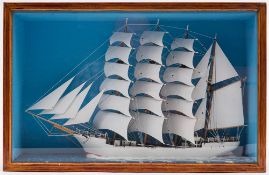 A scratch built model of a four masted clipper: set full sail with white painted hull on a painted