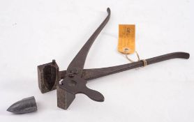 A 19th century steel double groove bullet mould by B Hodges:, 28cm long.