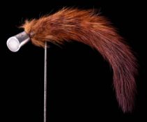 An Edwardian white metal mounted mink tail hat pin,: 17cm long.
