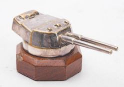A silver plated model of a Royal Navy gun emplacement on an octagonal wooden plinth:, 11.5cm long.