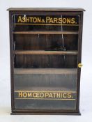 An early 20th century Retailers wall cabinet for 'Ashton & Parson Homoepathics':,