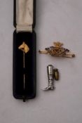 A 9ct gold Horse head stick pin by Garrard & Co, Ltd,