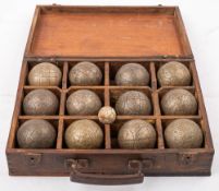 A cased set of bronze petanque: