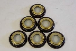 A set of six bronze circular portholes on mahogany bases,