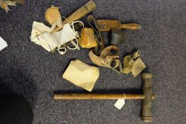 A group of four leather sailmaker's palms: together with a treen fid, a treen seam rubber,