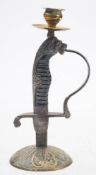 A Continental sword hilt candlestick: with brass sconce and mounted on a domed brass base,
