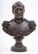 A bronzed resin bust of Napoleon: in military uniform on a socle base, 35cm. high.
