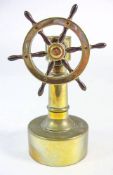 A late 19th/early 20th century Continental brass ship's helm cigar cutter:, unsigned, 15.5cm high.