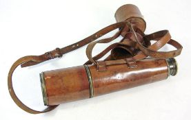 A leather and brass three draw telescope by ANCS Ltd Westminster.