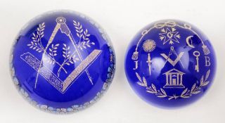 Two Masonic theme glass paperweights: decorated in blue and gilt, one with floral cane border,