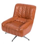 A tan leather and chrome swivel chair, circa 1970:.