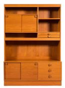A Danish teak dresser: with an arrangement of open shelves and cupboards with sliding doors,