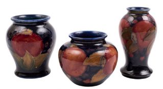 Three Moorcroft pottery small vases: two of baluster form and one squat globular example each