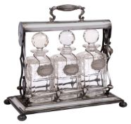 A late Victorian/Edwardian silver plated three bottle tantalus: with hinged handle and open frame