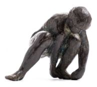 After Karel Vogel, a bronze figure of a crouching man: attending to his left foot, unsigned , 17cm.