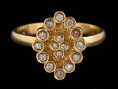 A diamond mounted oval cluster ring: set with round, brilliant-cut diamonds, ring size M.