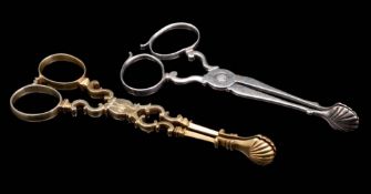 A pair of 19th century silver gilt sugar nips: crested, together with a pair of silver sugar nips,