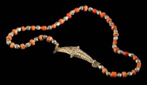 An Indo-Persian coral and silver gilt necklace: on silver gilt clasp with applied beaded decoration,