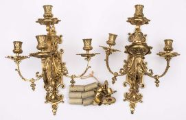 A pair of Victorian brass four-light wall sconces: with cartouche-shaped and scroll decorated