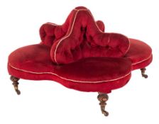 A Victorian carved walnut conversation seat: of quatrefoil outline,