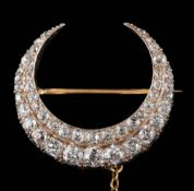 A Victorian diamond mounted two-row crescent brooch: set with graduated round old,