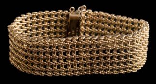 A 9ct gold pierced mesh-link bracelet: approximately 18cm long x 2.2cm wide, 49gms gross weight.