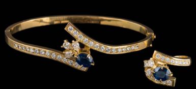 A modern 18ct gold sapphire and diamond cluster cross-over hinged bangle and matching ring: each